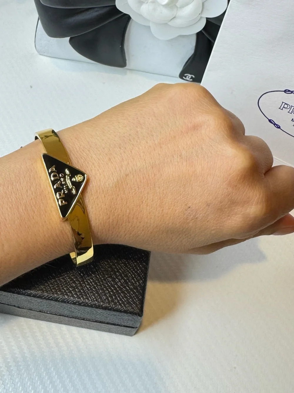 Prada Gold Tone Bangle with Black Triangle Logo Plaque